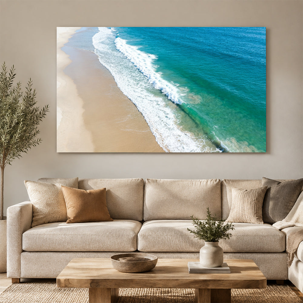Aerial Sand and Surf canvas wall art, living room mockup above a sofa.