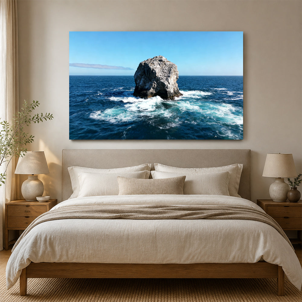 Solitary Sea Stack canvas wall art, bedroom mockup above a bed.