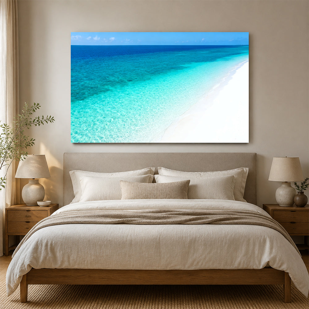 Clear Blue Sandbank canvas wall art, bedroom mockup above a bed.