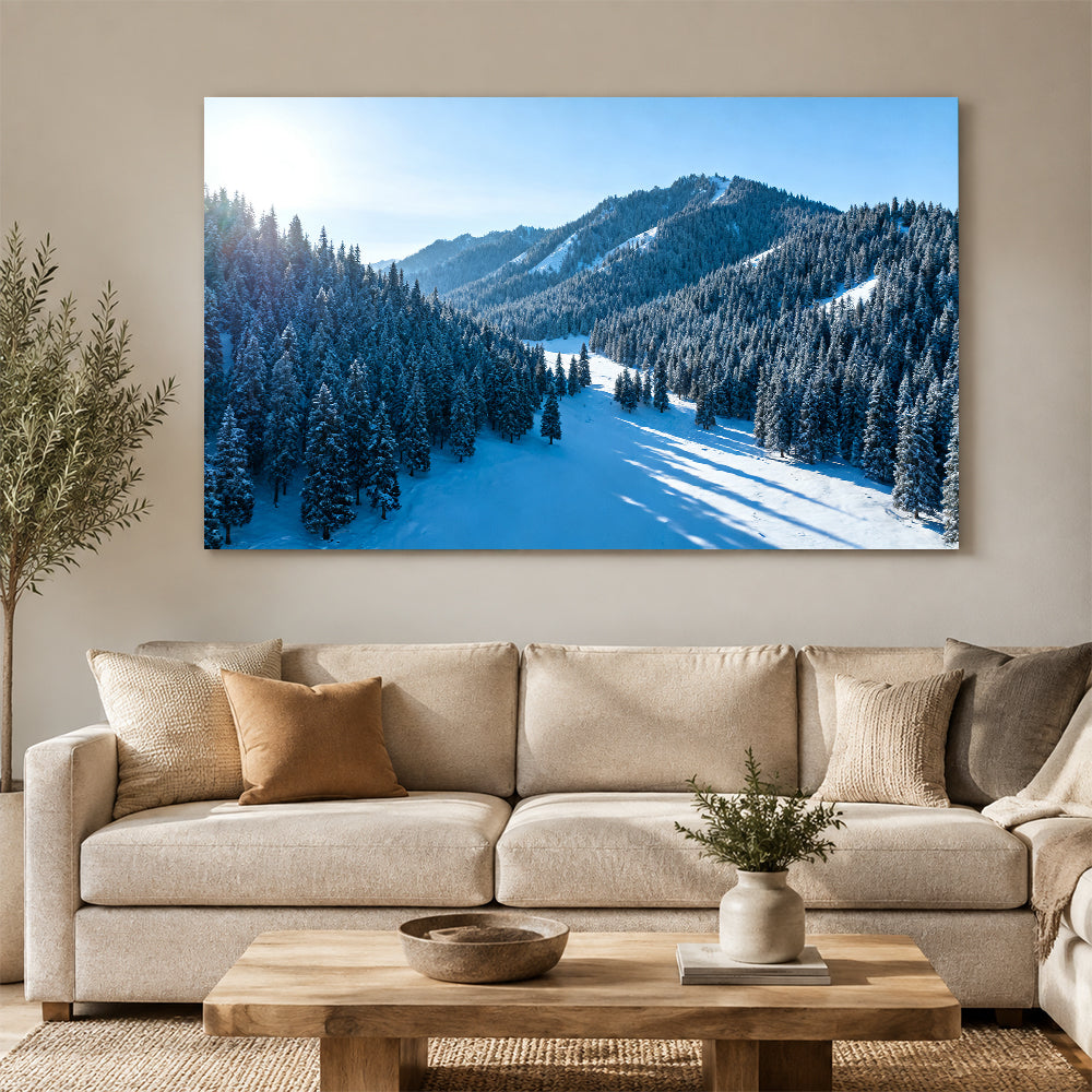 Snowy Woodland Valley canvas wall art, living room mockup above a sofa.