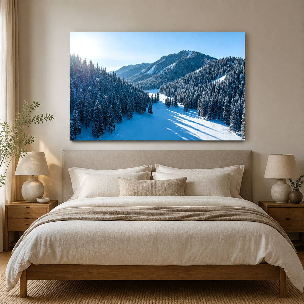 Snowy Woodland Valley canvas wall art, bedroom mockup above a bed.