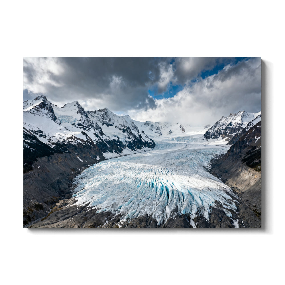 Icefall beneath Storm Clouds canvas wall art, front view on a white background.