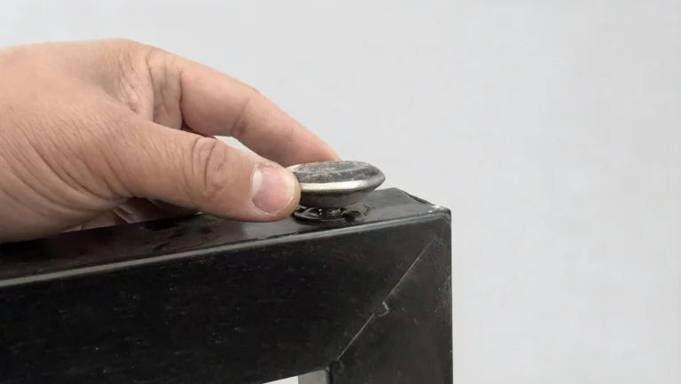 Feet being attached to unpacked metal table legs