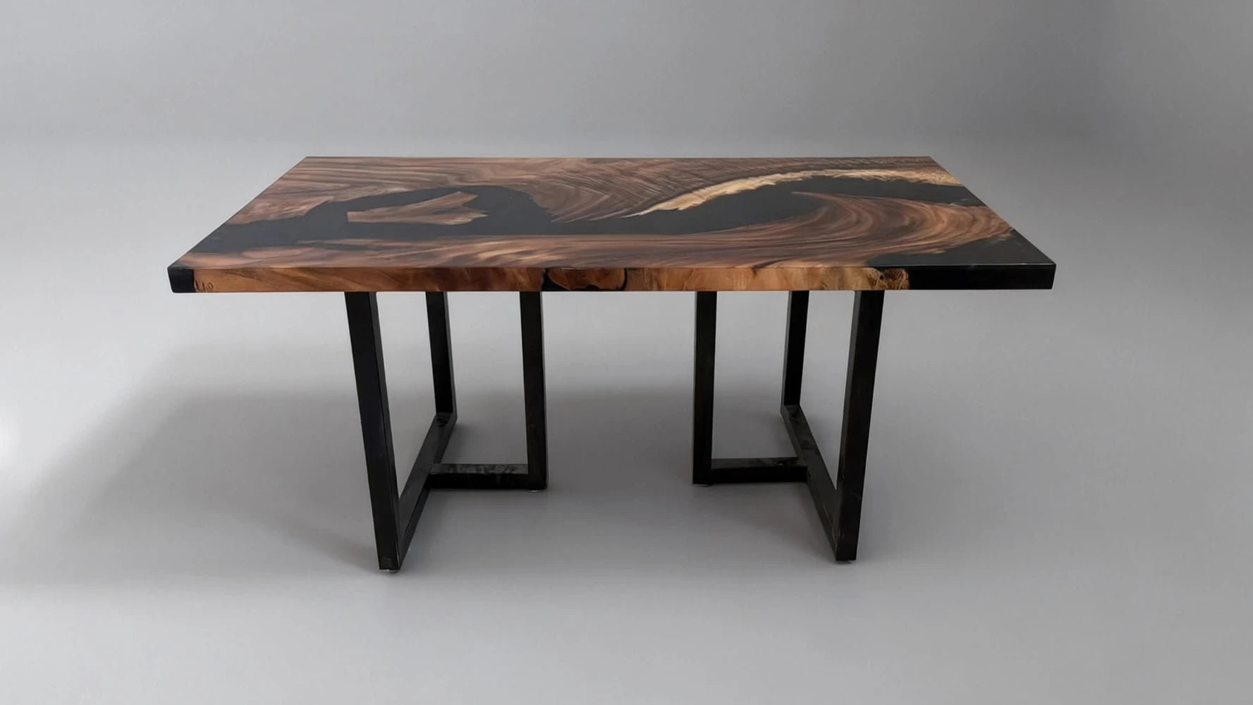 Resin tabletop being placed onto metal table legs