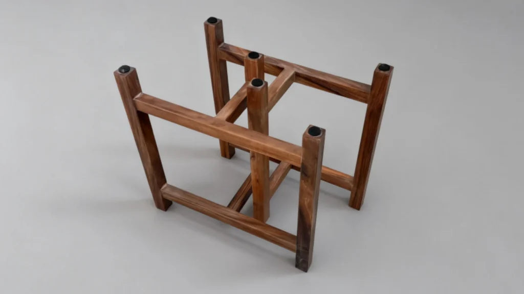 Anti-slip pads being applied to solid wood table legs